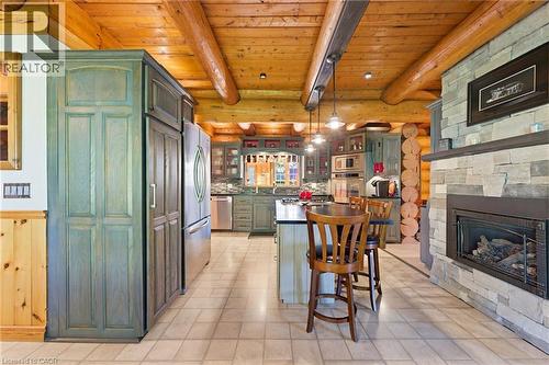 Exposed log beam ceiling - 169 James Street, Atwood, ON - Indoor With Fireplace
