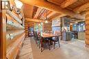 Open-concept main living area with log construction, exposed wood beams, stone accent wall, light-toned flooring, and recessed lighting - 169 James Street, Atwood, ON  - Indoor Photo Showing Dining Room 