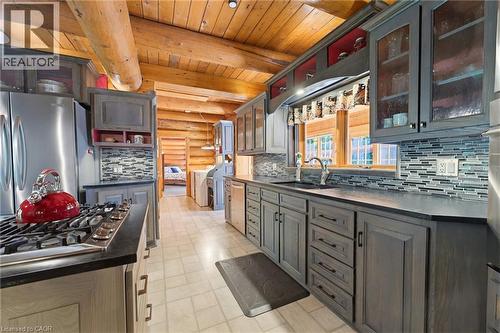 Spacious kitchen featuring gray cabinetry, stainless steel appliances, and a mosaic tile backsplash - 169 James Street, Atwood, ON - Indoor Photo Showing Kitchen