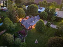 Expansive property featuring a multi-level home with a dark-toned roof and dormer windows - 