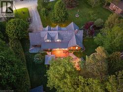 Expansive property featuring a multi-gabled roofline, multiple dormer windows, and a generously sized rear deck - 