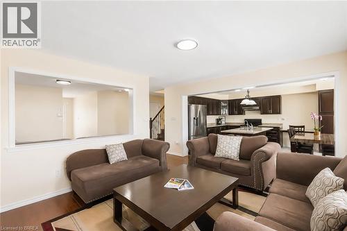 Expansive living area featuring wood-finish flooring and a neutral color palette - 26 Pollard Street, Brantford, ON - Indoor Photo Showing Living Room