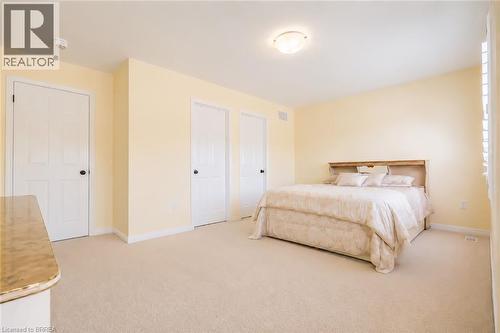 Carpeted room with light yellow walls and white trim - 26 Pollard Street, Brantford, ON - Indoor Photo Showing Bedroom