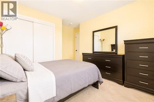 Bright room featuring light-colored carpeting and soft yellow wall tones - 26 Pollard Street, Brantford, ON - Indoor Photo Showing Bedroom