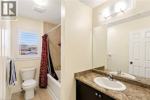 Bathroom featuring a built-in vanity with an integrated sink and a large wall mirror - 26 Pollard Street, Brantford, ON - Indoor Photo Showing Bathroom
