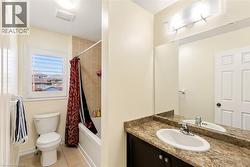 Bathroom featuring a built-in vanity with an integrated sink and a large wall mirror - 