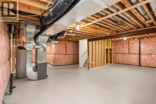 Unfinished basement presenting exposed wood joists and structural beams - 26 Pollard Street, Brantford, ON - Indoor Photo Showing Basement