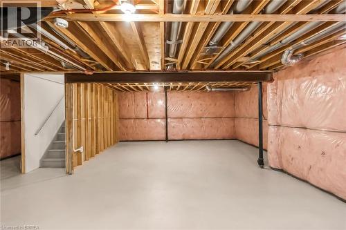 Unfinished basement space featuring exposed wood joists, insulated walls, and a concrete floor - 26 Pollard Street, Brantford, ON - Indoor Photo Showing Basement