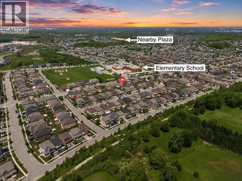 Aerial perspective of a residential community with an elementary school and commercial plaza - 26 Pollard Street, Brantford, ON -  With View