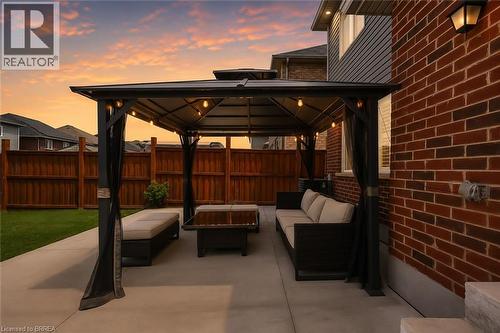 Expansive concrete patio featuring a gazebo with string lighting - 26 Pollard Street, Brantford, ON - Outdoor With Deck Patio Veranda With Exterior
