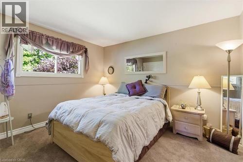 Bedroom featuring a window with white trim, light beige wall paint, and light brown carpeting - 26 Sideroad 18, Fergus, ON - Indoor Photo Showing Bedroom