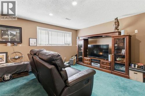 Entertainment area featuring a large built-in media center with display cabinetry, recessed lighting, and a window with horizontal blinds - 26 Sideroad 18, Fergus, ON - Indoor
