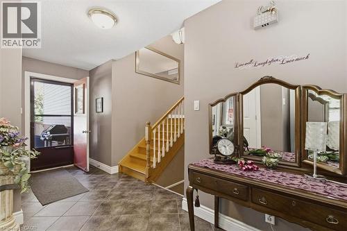Foyer featuring tiled flooring, a screen door entry, and a wood staircase with white balusters - 26 Sideroad 18, Fergus, ON - Indoor Photo Showing Other Room