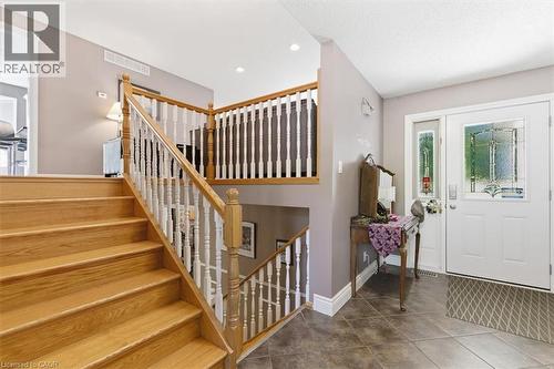 Entryway featuring wood-finish staircase with white balusters and natural wood handrail - 26 Sideroad 18, Fergus, ON - Indoor Photo Showing Other Room