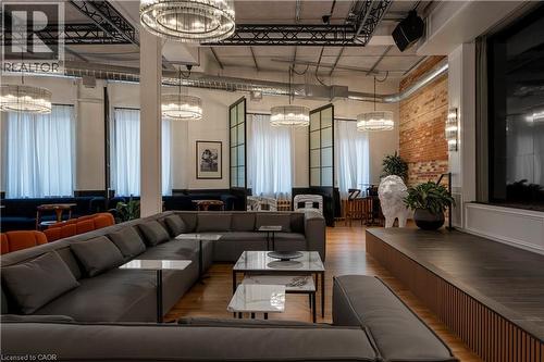 Spacious interior featuring exposed brick accents and a multi-level platform - 14 Erb Street W, Waterloo, ON 