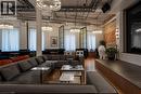 Spacious interior featuring exposed brick accents and a multi-level platform - 14 Erb Street W, Waterloo, ON 