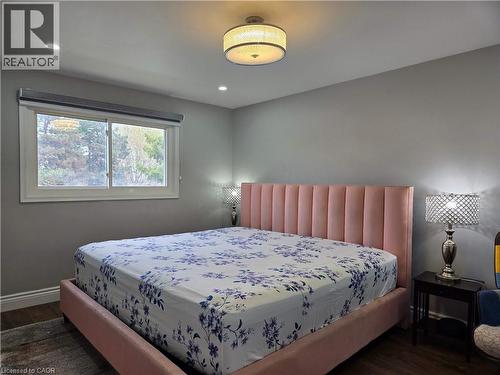Bedroom featuring recessed lighting, a central drum ceiling fixture, and wood-finish flooring - 261 Overlea Drive, Kitchener, ON 