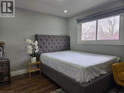 Recessed lighting illuminates this room featuring wood-finish flooring - 