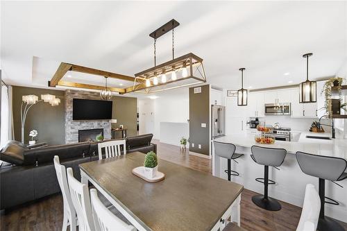 43 Seine River Crossing, Ste Anne, MB - Indoor Photo Showing Dining Room With Fireplace