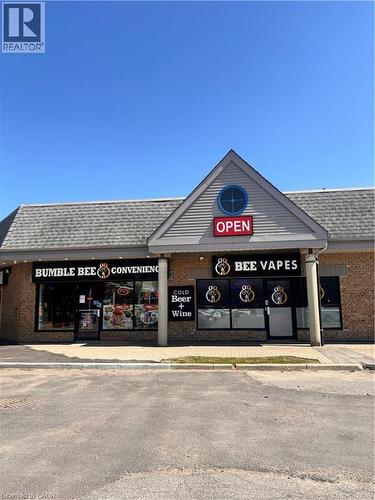 Commercial storefront with a gabled facade featuring horizontal siding and a circular accent window - 1400 Weber Street E Unit# A5, Kitchener, ON 
