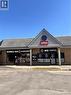 Commercial storefront with a gabled facade featuring horizontal siding and a circular accent window - 1400 Weber Street E Unit# A5, Kitchener, ON 