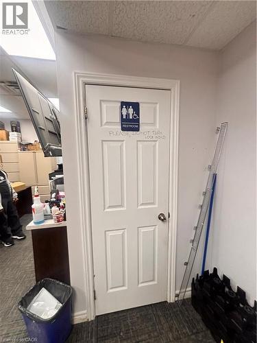 Four-panel white interior door with a chrome-finish doorknob and visible hinges - 277 Lancaster Street W, Kitchener, ON 