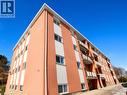 Brick exterior featuring white vertical accents and multiple balconies with metal railings - 223 Heiman Street, Kitchener, ON  - Outdoor 