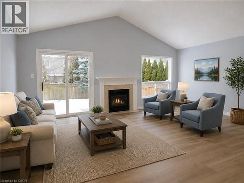 Living space featuring a vaulted ceiling and wood-finish flooring - 732 Angler Way, Waterloo, ON - Indoor Photo Showing Living Room With Fireplace