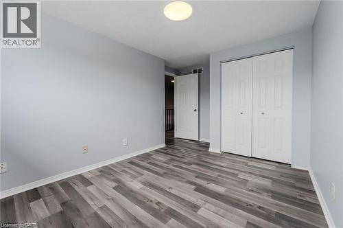 Room featuring wood-finish flooring, light gray walls, and white trim - 732 Angler Way, Waterloo, ON - Indoor Photo Showing Other Room