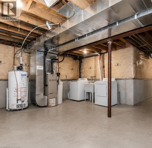 Concrete flooring basement with exposed ceiling beams and ductwork - 732 Angler Way, Waterloo, ON - Indoor Photo Showing Basement