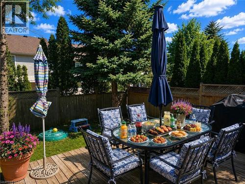 Wood-finish deck featuring a dining area with an umbrella - 732 Angler Way, Waterloo, ON - Outdoor With Deck Patio Veranda