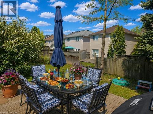 Spacious wooden deck with an oval glass-top patio table - 732 Angler Way, Waterloo, ON - Outdoor With Deck Patio Veranda