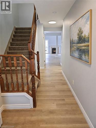 Entryway featuring wood-finish flooring and a carpeted staircase with wood banister - 732 Angler Way, Waterloo, ON - Indoor Photo Showing Other Room