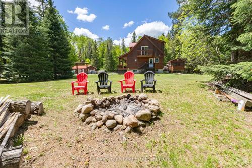 Enjoying the property with a stone firepit - 1291 South Wilberforce Road, Highlands East (Monmouth), ON 