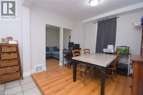 Dining area featuring wood-finish flooring and light gray walls - 12 Wood Street W, Hamilton, ON - Indoor Photo Showing Dining Room