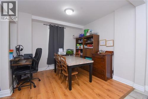 Interior space featuring wood-finish flooring, light-toned walls, and a window with dark drapery - 12 Wood Street W, Hamilton, ON - Indoor Photo Showing Office