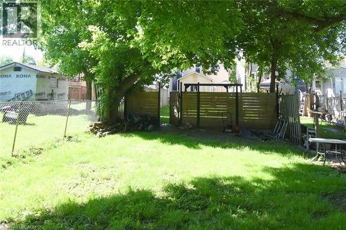 Expansive grassy yard area with mature trees providing shade - 12 Wood Street W, Hamilton, ON - Outdoor