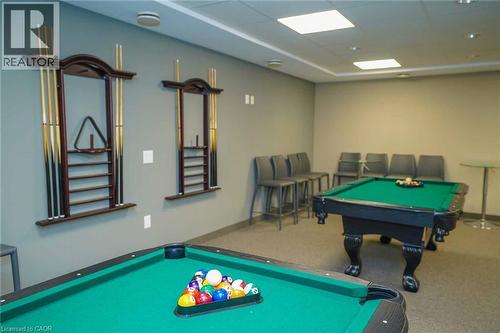 Recreation room featuring two billiards tables with green felt surfaces, recessed ceiling lighting, and overhead square light panels - 7 Kay Crescent Unit# 107, Guelph, ON 
