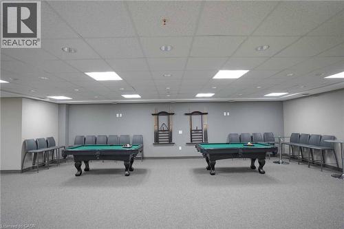 Recreation room featuring two pool tables, recessed lighting, drop ceiling, and carpeted flooring - 7 Kay Crescent Unit# 107, Guelph, ON 
