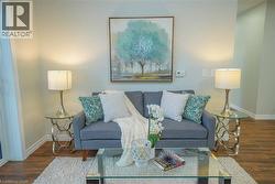 Neutral wall paint and wood-finish flooring create a bright living space - 