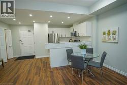 Open-concept living area featuring wood-finish flooring and recessed lighting - 