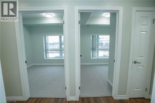 Light-filled interiors featuring wood-finish flooring, neutral wall tones, and recessed lighting - 7 Kay Crescent Unit# 107, Guelph, ON 