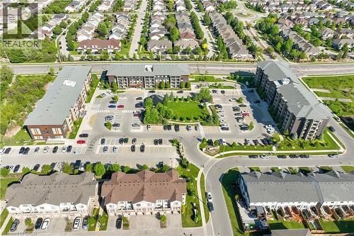 Aerial perspective showcasing a residential development with multiple multi-story apartment buildings - 7 Kay Crescent Unit# 107, Guelph, ON 