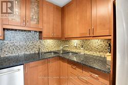 Kitchen with granite counters & corner sink - 