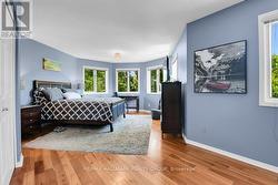 Primary bedroom has bay wall of windows. - 