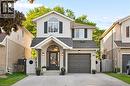 Two-story residence featuring light-toned siding and brick accents - 214 Grey Fox Drive, Kitchener, ON 