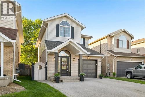 Two-story residence featuring light brick and siding exterior - 214 Grey Fox Drive, Kitchener, ON 
