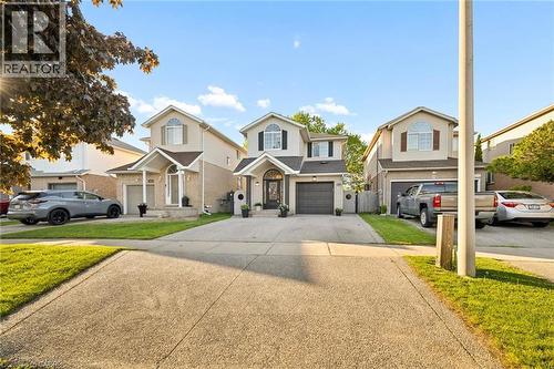 Two-story residence featuring a covered entryway, an integrated single-car garage, and a light-toned brick facade with coordinating siding - 214 Grey Fox Drive, Kitchener, ON 