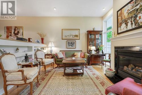 HARDWOOD FLOORS THROUGHOUT - 13 Oak Park Private, Ottawa, ON - Indoor Photo Showing Living Room With Fireplace