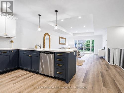 Kitchen with blue lower cabinets - 18 - 86 Eagle Court, Saugeen Shores, ON 